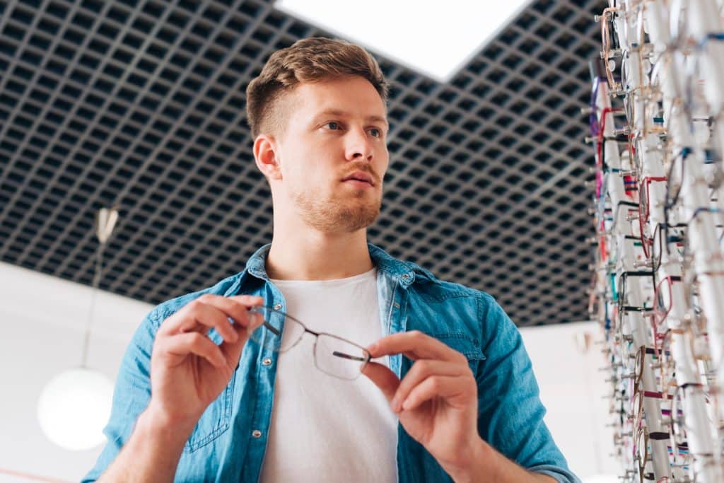 a MAN IS EXPLORING PLASTIC EYEGLASSES FRAMES COLLECTIONS online at Vazeer Optical Hall website.