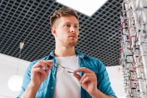 a MAN IS EXPLORING PLASTIC EYEGLASSES FRAMES COLLECTIONS online at Vazeer Optical Hall website.